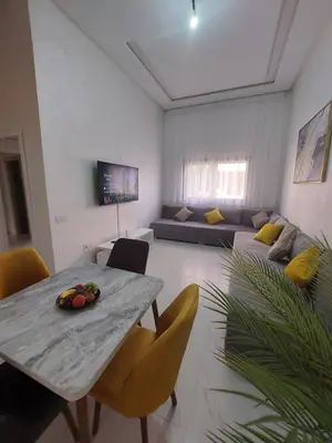 a living room with a table and a couch at Centre Marrakech, Chic et Calme in Marrakech