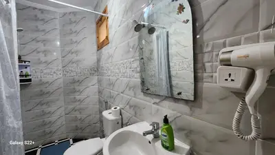 a bathroom with a sink and a mirror at Appartement B à 7min de l’aéroport de Marrakech in Marrakech