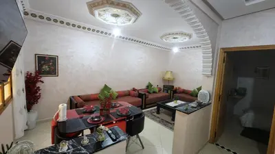 a living room with a couch and a table at Appartement B à 7min de l’aéroport de Marrakech in Marrakech