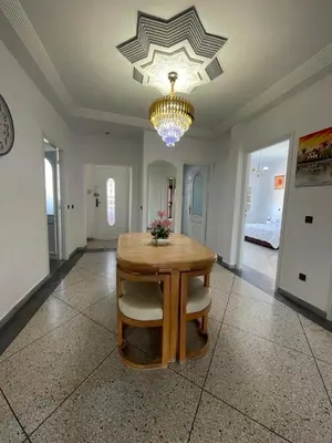 a dining room with a table and a chandelier at Luxury Apartment in Marrakesh in Marrakech