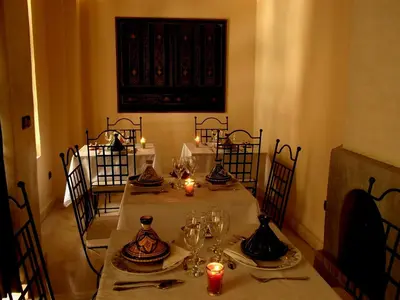 a dining room with a table with candles on it at Riad Signature in Marrakech