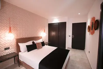 a bedroom with a large white bed in a room at Riad La Petite Majorelle in Marrakech