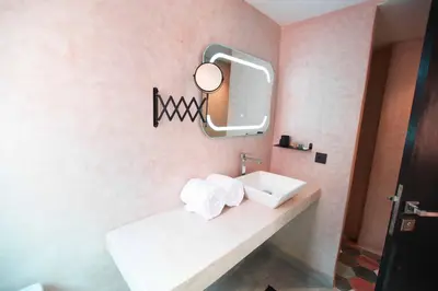 a bathroom with a sink and a mirror at Riad La Petite Majorelle in Marrakech