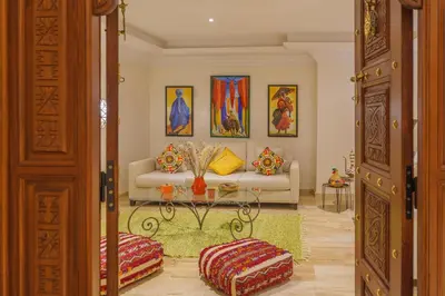 a living room with a couch and a table at Luxueux 138 m2 avec piscine in Marrakech