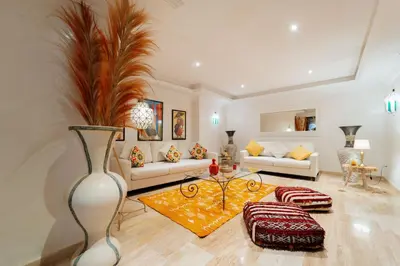 a living room with a couch and a table at Luxueux 138 m2 avec piscine in Marrakech