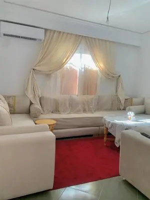 a living room with a couch and a window at Belle Appartement familiale,couple marié in Marrakech