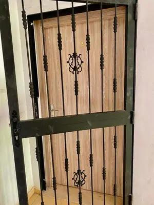 a wooden door with a gate in a room at Belle Appartement familiale,couple marié in Marrakech