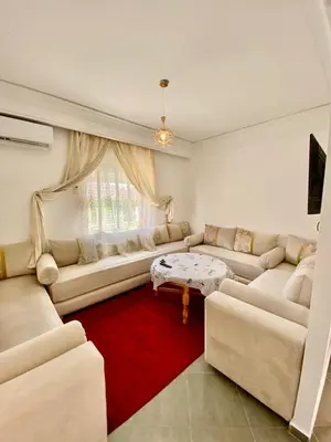 a living room with two couches and a red rug at Belle Appartement familiale,couple marié in Marrakech