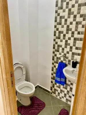 a bathroom with a toilet and a sink at Belle Appartement familiale,couple marié in Marrakech