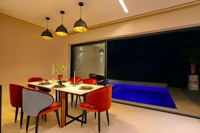 a dining room with a table and red chairs at Duplex de luxe, piscine sauna in Marrakech