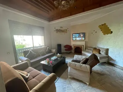 a living room with couches and a fire place at Au Riad de la Palmeraie - Marrakech in Marrakech