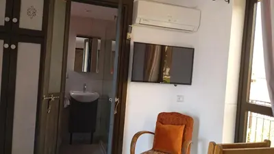 a bathroom with a sink and a mirror and a chair at Dar L'hna in Marrakech