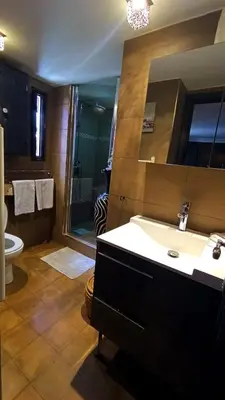 a bathroom with a sink and a shower and a toilet at Dar L'hna in Marrakech
