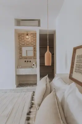 a bedroom with a bed and a bathroom with a sink at Riad Casa Kasbah in Marrakech