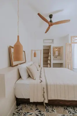 a bedroom with a bed and a ceiling fan at Riad Casa Kasbah in Marrakech
