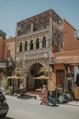 a woman walking down a street in front of a building at Riad Casa Kasbah in Marrakech