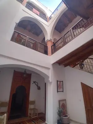 a living room with a ceiling with a balcony at Riad Rayan in Marrakech