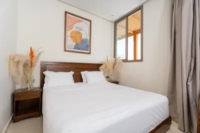 a bedroom with a white bed and a window at Dar Nourdha in Marrakech