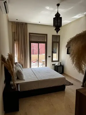 a bedroom with a large bed and a window at Dar Nourdha in Marrakech