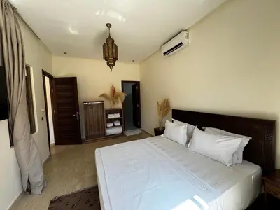 a bedroom with a large white bed in a room at Dar Nourdha in Marrakech