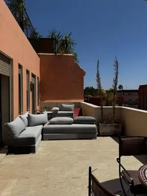 a patio with couches on the side of a building at Dar Nourdha in Marrakech