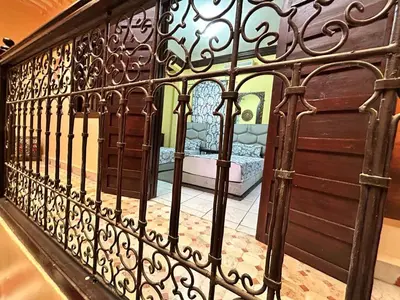 an iron fence with a bed in a room at Riad Lahbiba in Marrakech