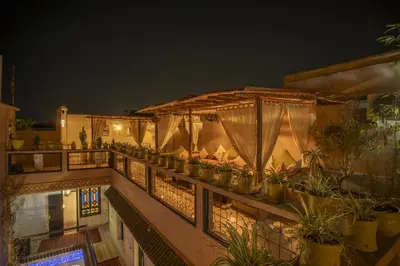 a balcony with a lot of potted plants on it at Riad Tala in Marrakech
