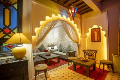 a living room with a couch and a table at Riad Tala in Marrakech