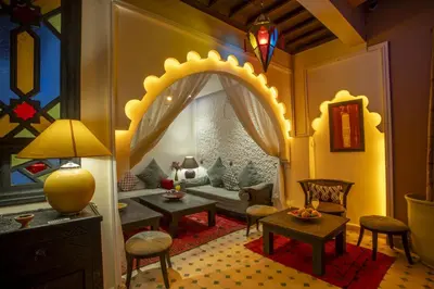 a living room with a couch and a table at Riad Tala in Marrakech