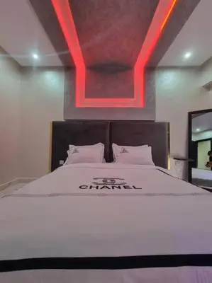 a bedroom with a bed with a red light above it at Kech vacations Friendly! Luxury 2 bed apartment in Marrakech