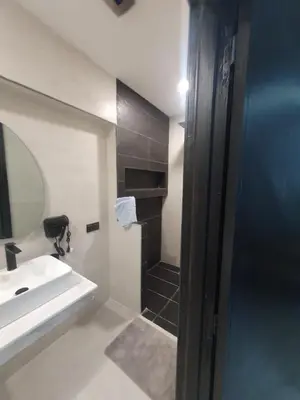 a bathroom with a sink and a mirror at Kech vacations Friendly 2 Bedroom Luxury apartment in Marrakech