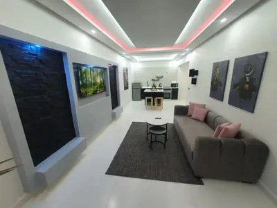 a living room with a couch and a table at Kech vacations Friendly 2 Bedroom Luxury apartment in Marrakech
