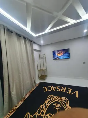 a room with a bed with a poster on the wall at Kech vacations Friendly 2 Bedroom Luxury apartment in Marrakech