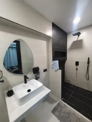 a bathroom with a white sink and a mirror at Kech vacations Friendly 2 Bedroom Luxury apartment in Marrakech