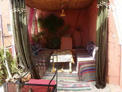 a room with couches and a table in a house at Riad Espagne in Marrakech