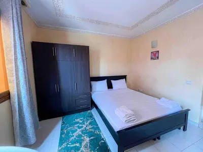 a bedroom with a bed and a dresser in it at Appartamento nel quartiere Gueliz , Marrakech in Marrakech