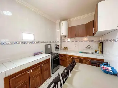 a kitchen with wooden cabinets and a white counter top at Appartamento nel quartiere Gueliz , Marrakech in Marrakech