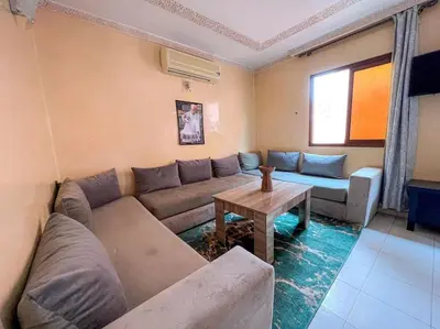 a living room with a couch and a table at Appartamento nel quartiere Gueliz , Marrakech in Marrakech