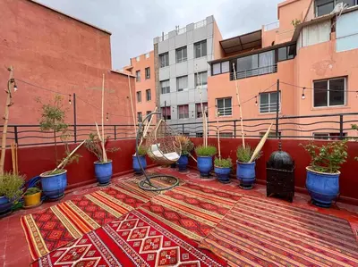 a balcony with a rug and potted plants on it at Appartamento nel quartiere Gueliz , Marrakech in Marrakech