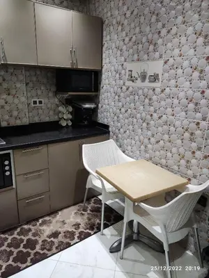 a kitchen with a table and chairs in a room at Luxury villa near airport & City center in Marrakech