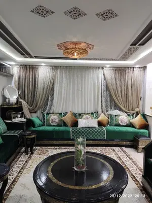 a living room with green couches and a table at Luxury villa near airport & City center in Marrakech