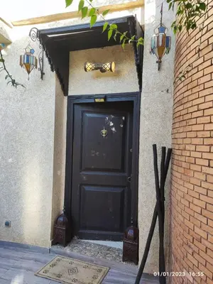a black door with a trumpet on the side of a building at Luxury villa near airport & City center in Marrakech