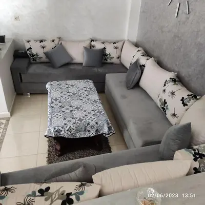 a living room with a couch and a table at Luxury villa near airport & City center in Marrakech