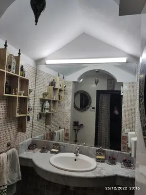 a bathroom with a sink and a large mirror at Luxury villa near airport & City center in Marrakech