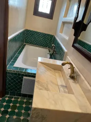 a bathroom with a sink and a bath tub at RIAD LAICHI in Marrakech