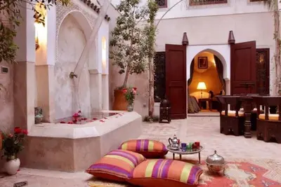 a room with a fountain in the middle of a building at Riad Dar Rania Marrakech Médina Jemaa El Fna in Marrakech