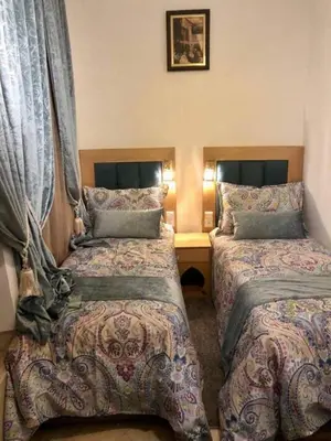 a hotel room with two beds and curtains at Riad Dar Rania Marrakech Médina Jemaa El Fna in Marrakech