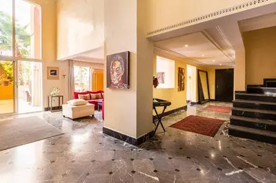 a living room with a staircase and a lobby at Somptueux Duplex au coeur de l'Hivernage in Marrakech
