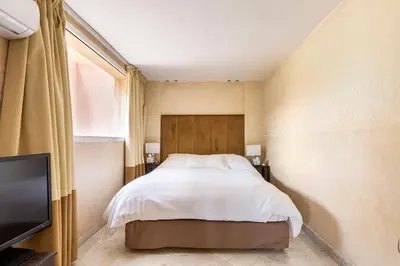 a bedroom with a bed and a flat screen tv at Somptueux Duplex au coeur de l'Hivernage in Marrakech