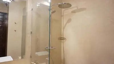 a shower with a glass door in a bathroom at RIAD KALE POLIS in Marrakech